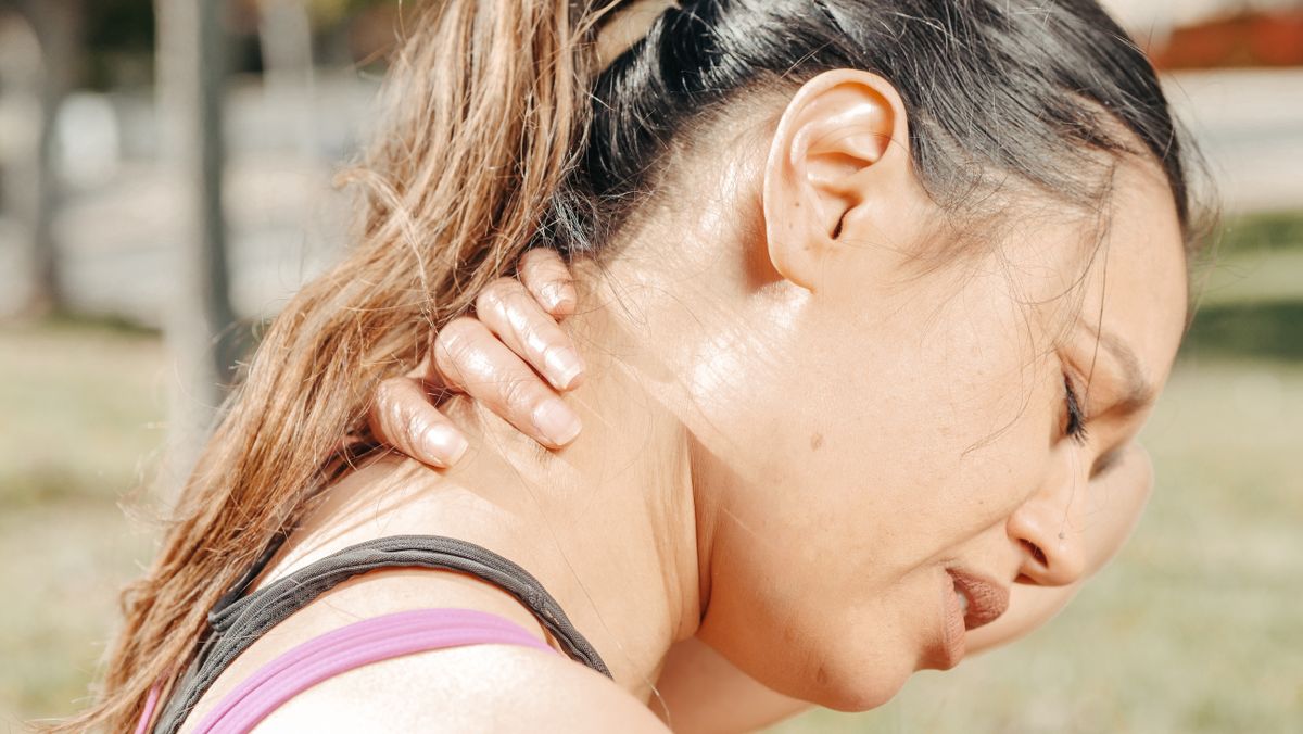Motor vehicle accident lawyer supporting a woman in pain holding her neck in California